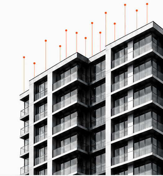 Modern condominium building with orange data markers along its rooftop